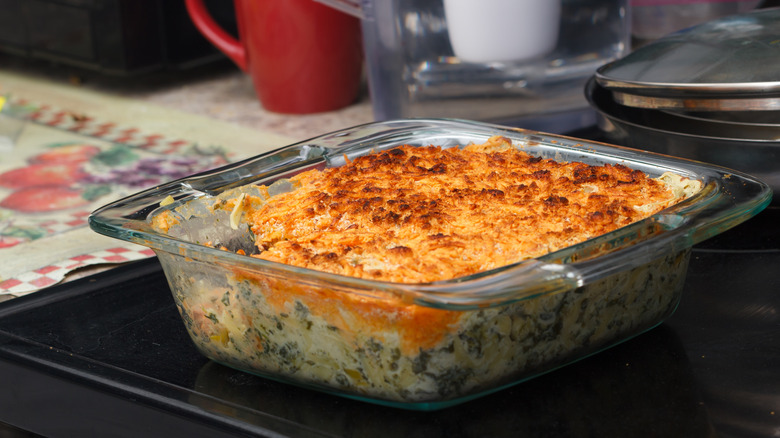 A tuna casserole in a glass casserole dish in an old-fashioned kitchen