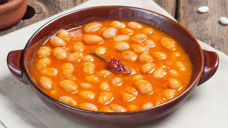 Spicy navy bean soup in a brown bowl