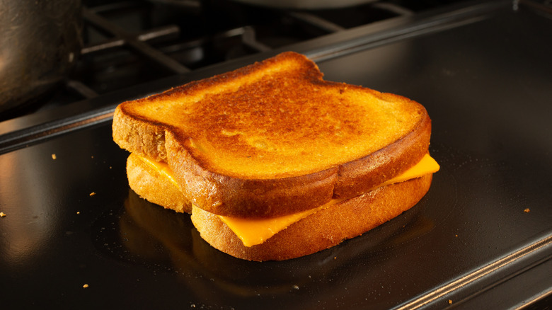 Close-up of a grilled cheese sandwich on a flat-top griddle