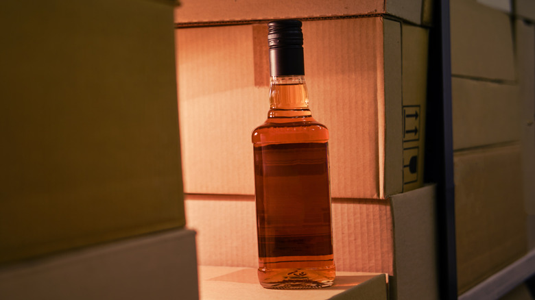 A lone bottle of imported whisky among boxes during shipping