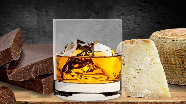 bourbon in front of cheese and chocolate 