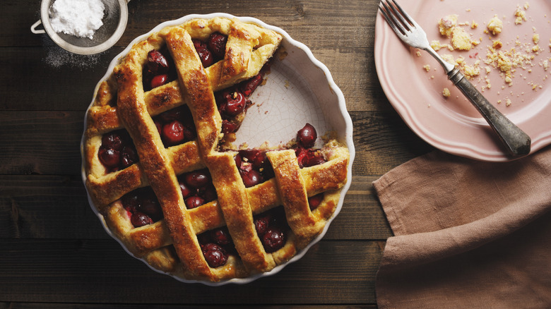 homemade cherry pie with a piece missing