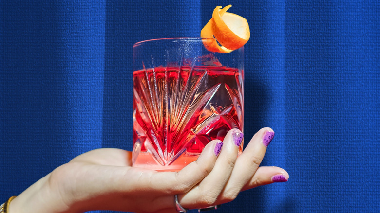 hand holding Negroni