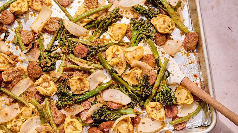 Tortellini and sausage bake on baking sheet