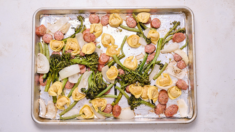 roasted sausage and tortellini on a sheet tray