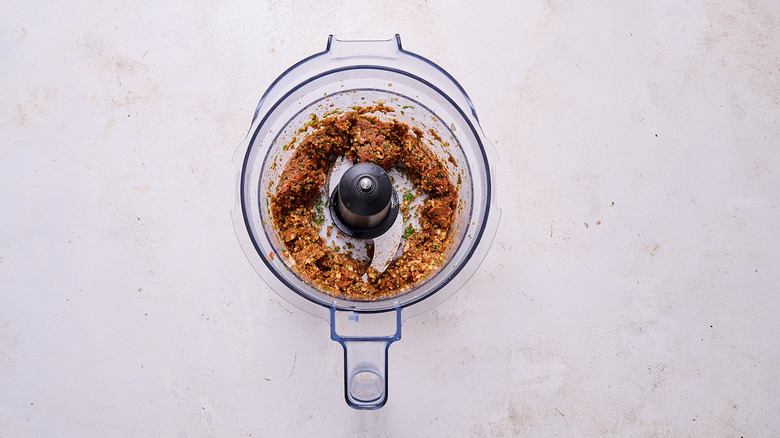 red pesto ingredients chopped in food processor