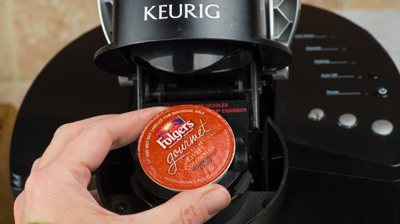 inserting K-cup into Keurig machine
