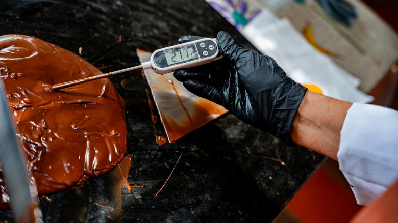 Person using instant thermometer chocolate