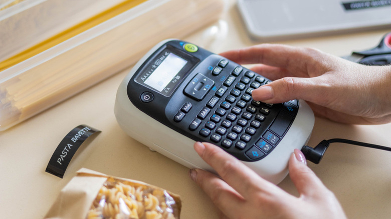 Woman using label maker for pasta