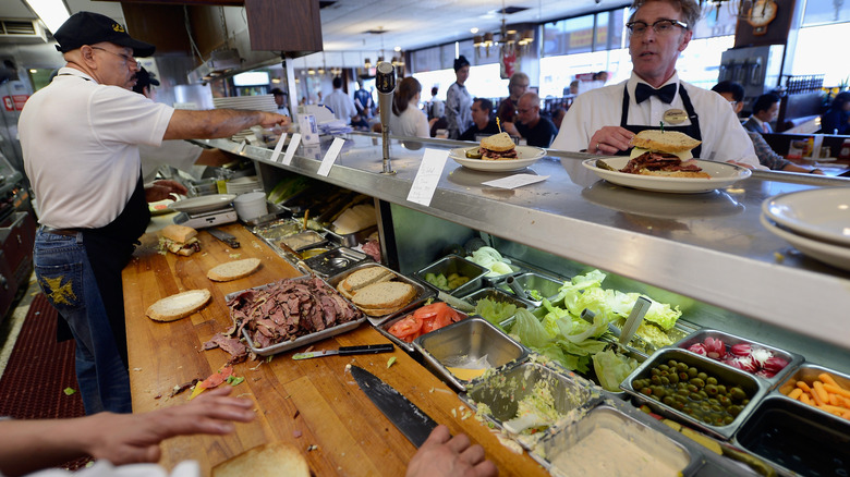 preparing a pastrami sandwich at Langer's Deli