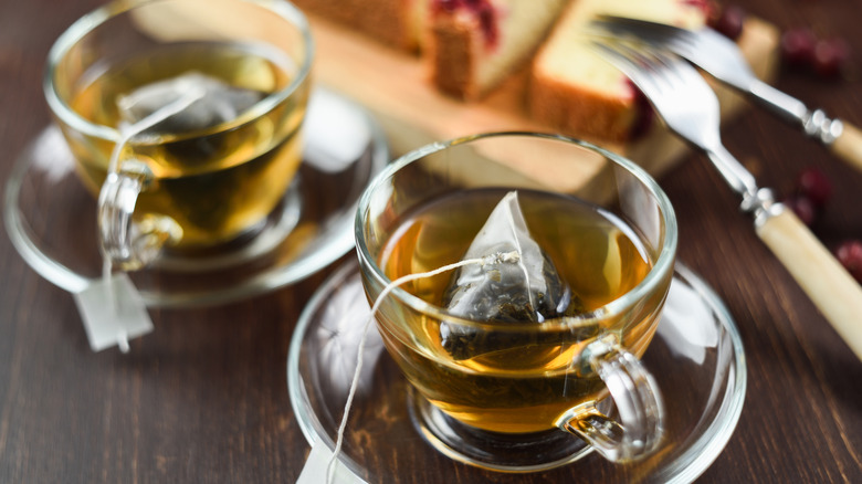 Two cups of green tea with tea bags