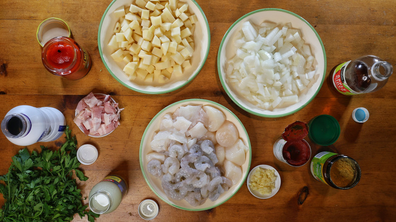 Long Island seafood chowder ingredients laid out on a wooden table