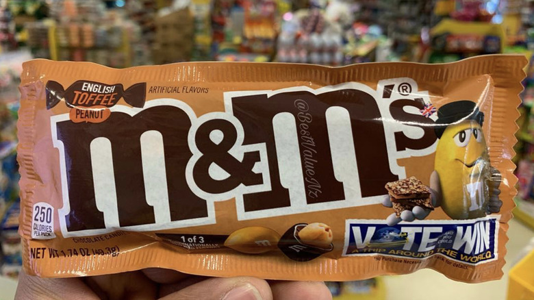 customer holding M&M's package