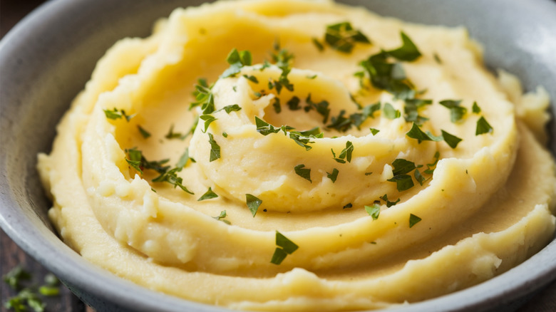 Bowl of mashed potatoes with herbs