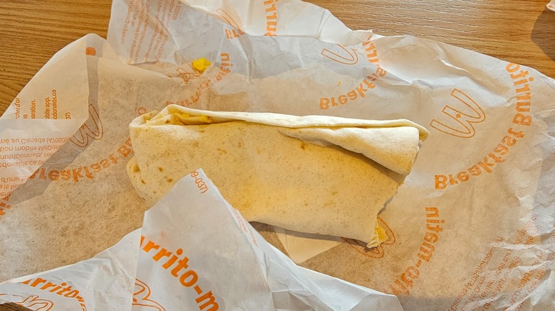 McDonald's breakfast burrito sitting in the wrapper
