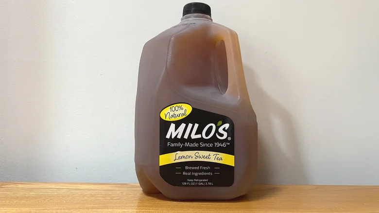A carton of Milo's Lemon Sweet Tea on a table against a white background