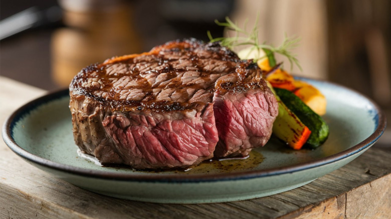 Steak with vegetables on plate