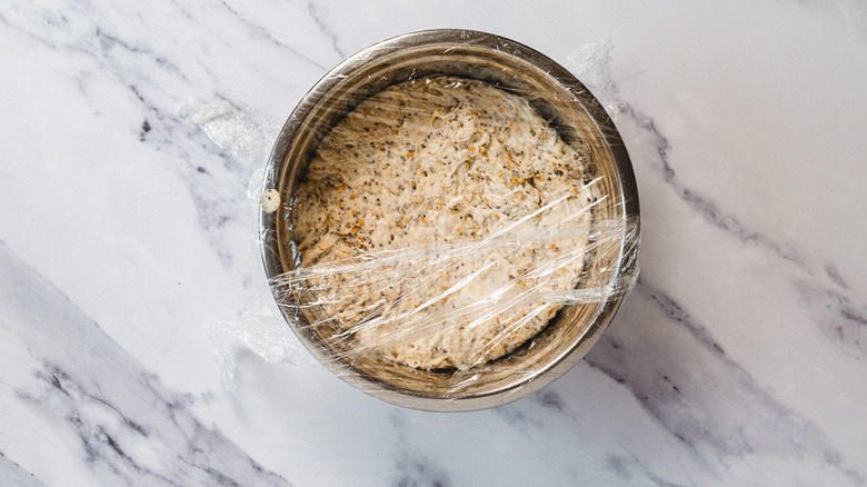 Dough in bowl with plastic wrap