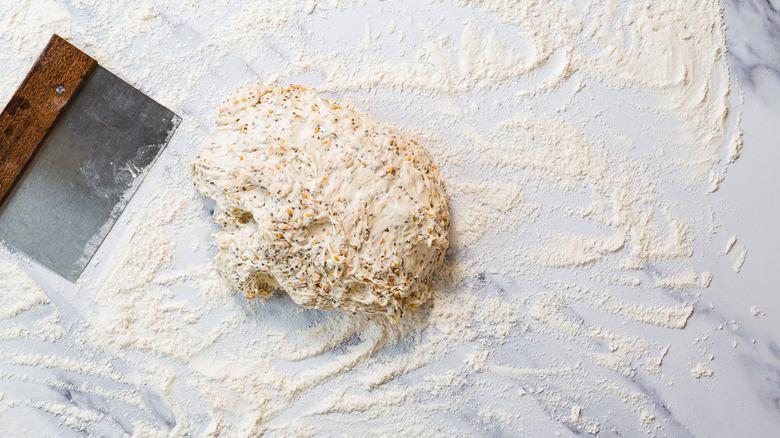 Dough on counter with dough scraper