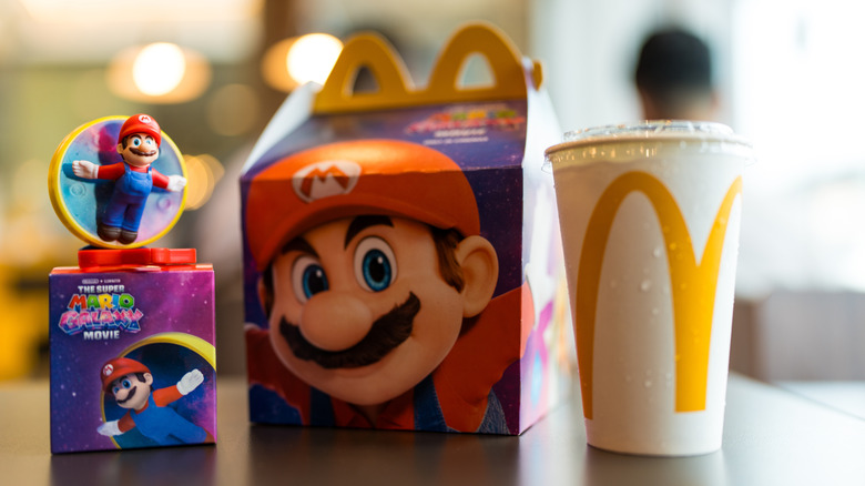 A McDonald's Happy Meal featuring the box, drink, and toy on a restaurant table