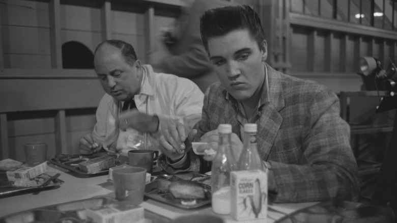 Elvis Presley eating in a restaurant
