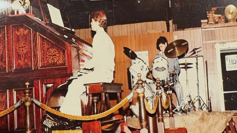 Vintage photo of organist and drummer on stage inside Cap'ns Galley Pizza & Pipes restaurant