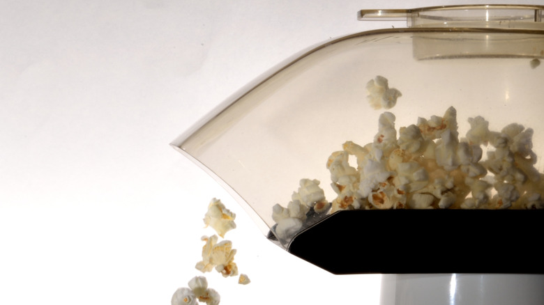 Popcorn falling out of an air popper
