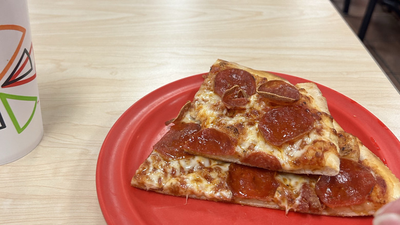 A slide of pizza and drink from Cicis