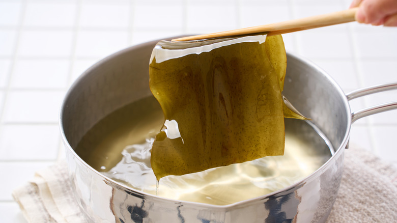 Chopsticks picking kombu from pot