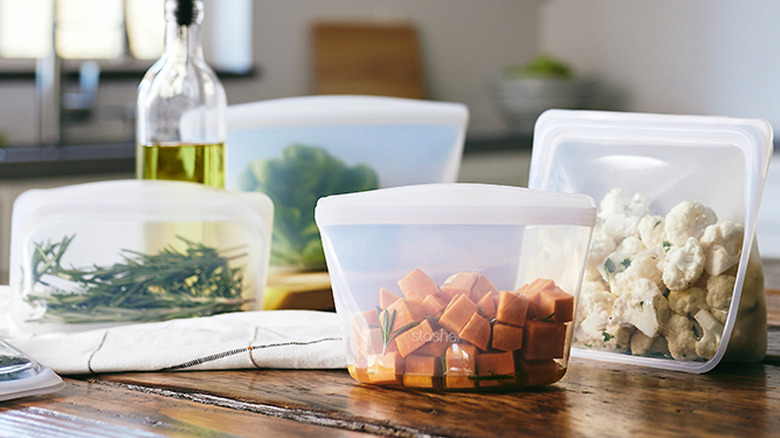 four silicone storage bags filled with food
