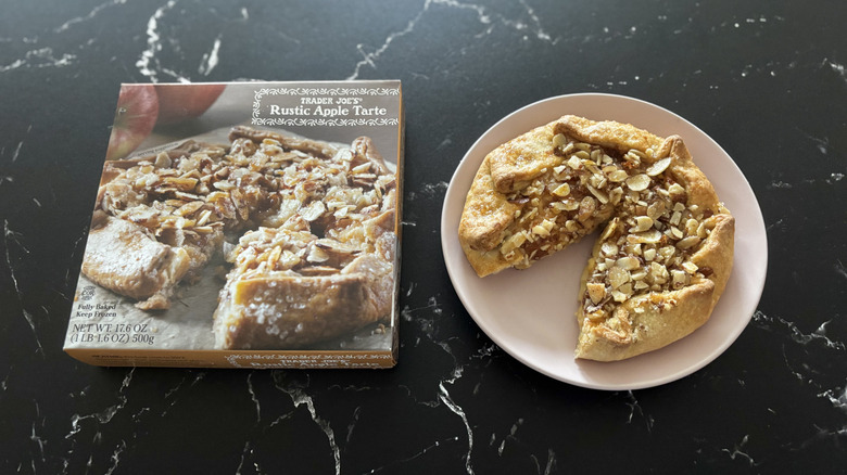 Trader Joe's Rustic Apple Tarte dessert on pink plate next to product's cardboard box