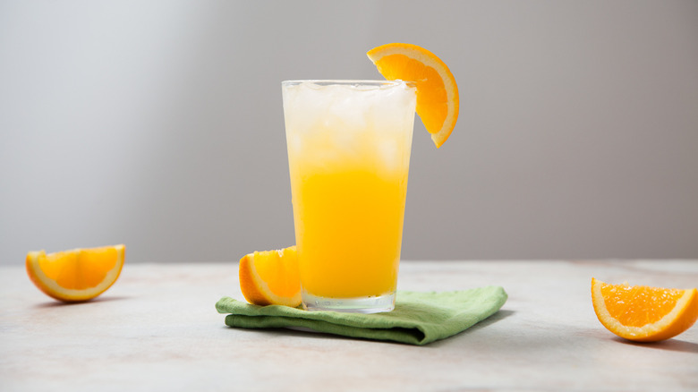 orange cocktail served on table