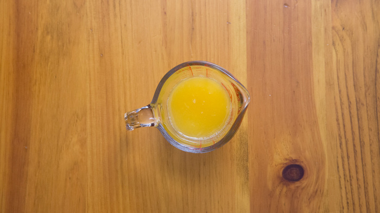 orange juice in measuring cup