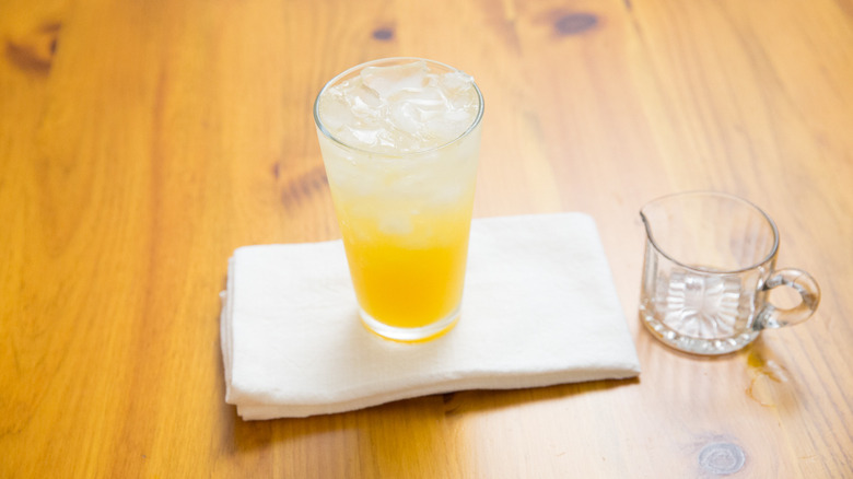 orange cocktail on wooden table