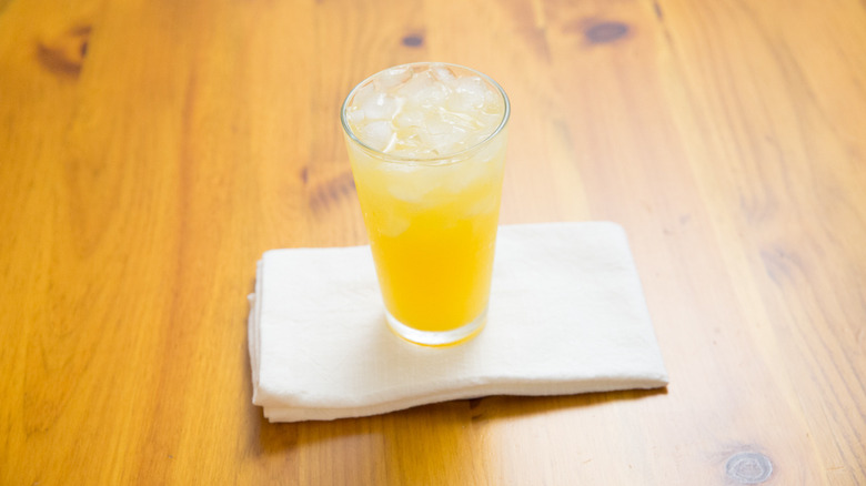 orange cocktail on wooden table