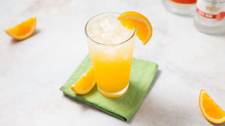 orange cocktail served on table