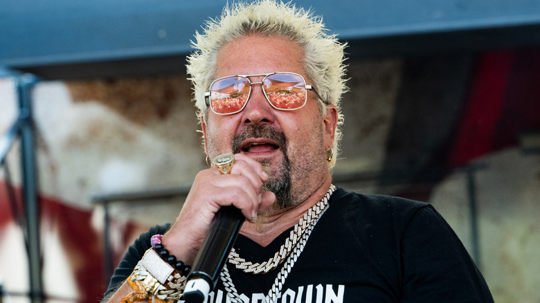 Guy Fieri speaking into a microphone