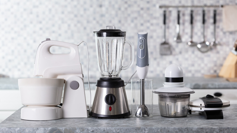 Several small kitchen appliances on a kitchen counter.