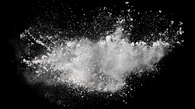 An explosive burst of white sugar powder.