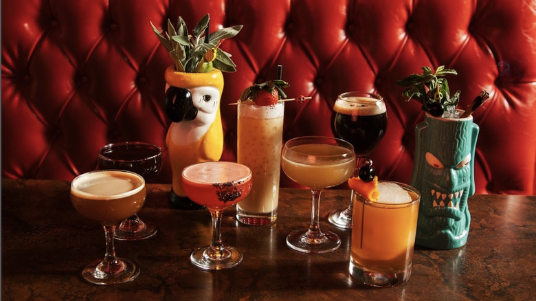 red booth and table of several different cocktails at the Ranstead Room