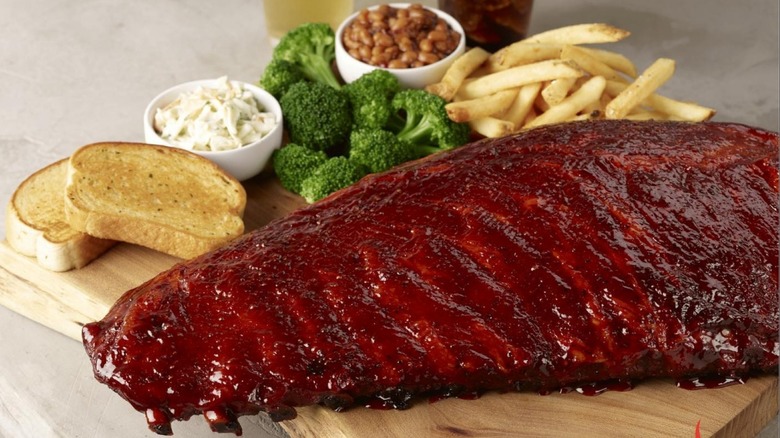 A plate of Smokey Bones ribs with sides
