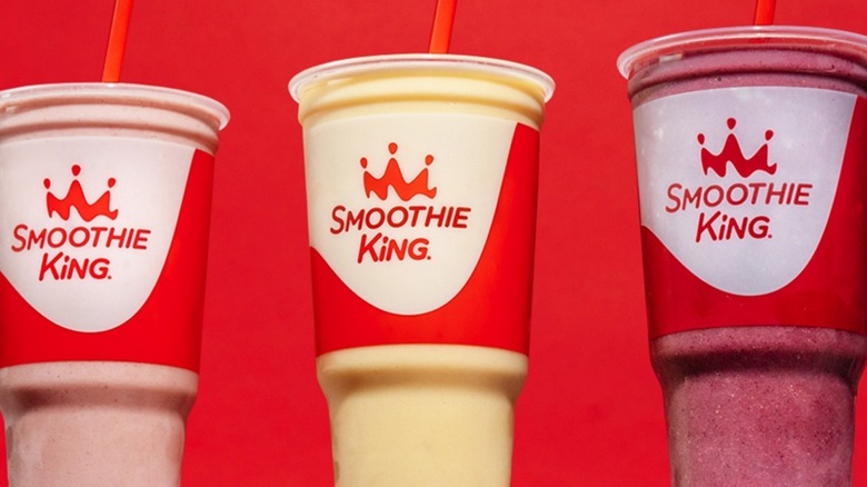 Three Smoothie King smoothies in front of a red background