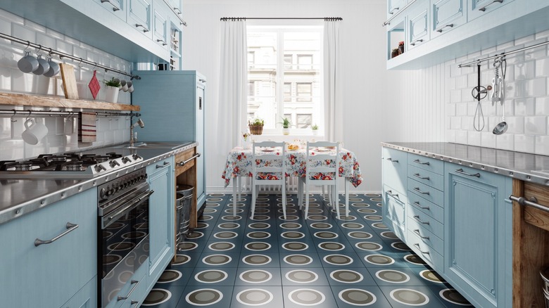 a retro blueish kitchen with tiled floor