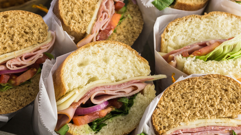 Fresh sub sandwiches on white and wheat hoagies