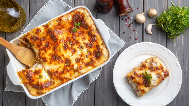 overhead view of dish of lasagna with slice on plate