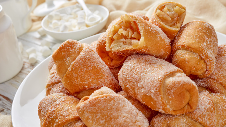 A pile of sugared apple pie crescent rolls