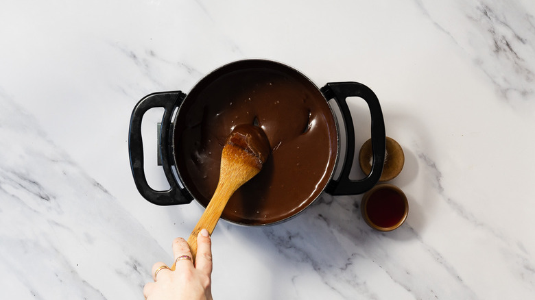 Mixing melted chocolate and cream in fondue pot