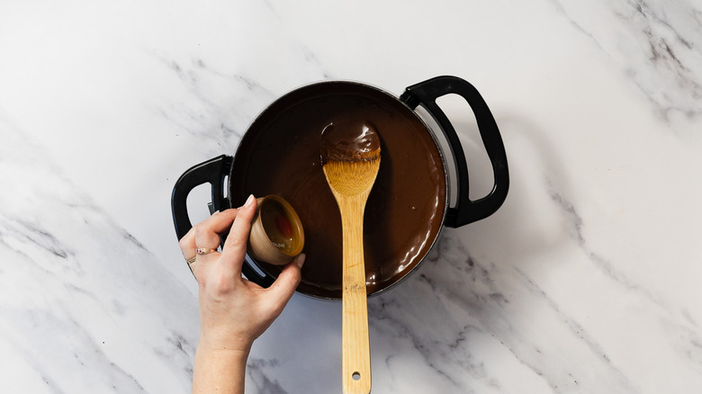 Adding raspberry liqueur to chocolate fondue