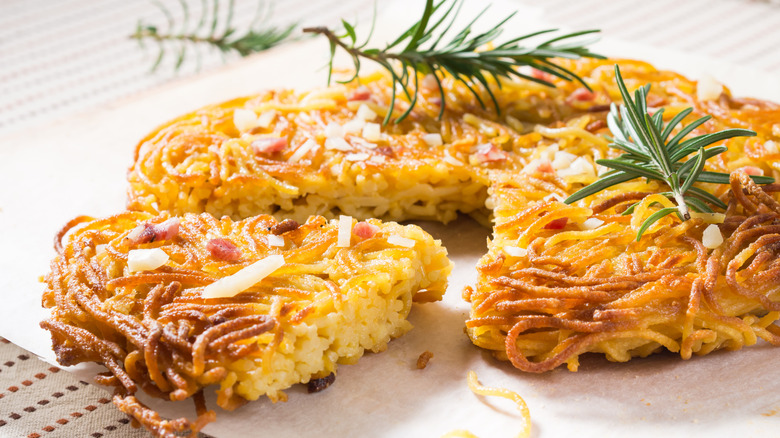 spaghetti pie garnished with rosemary