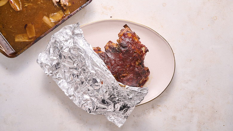 lamb tented on a plate with foil